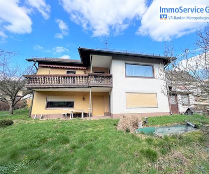 Einfamilienhaus mit Garage und Nebengebäuden auf großem Grundstück mit Talblick