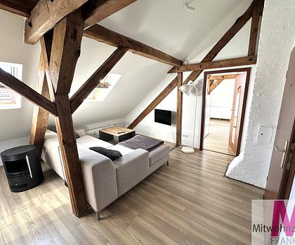 Stilvolles Wohnen unter dem Dach  Hochwertig möblierte 2-Zimmer-Wohnung mit sichtbaren Holzbalken